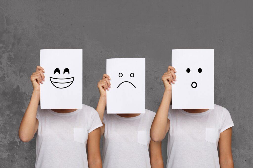 Girl covering face with white boards. Set of painted emotions
